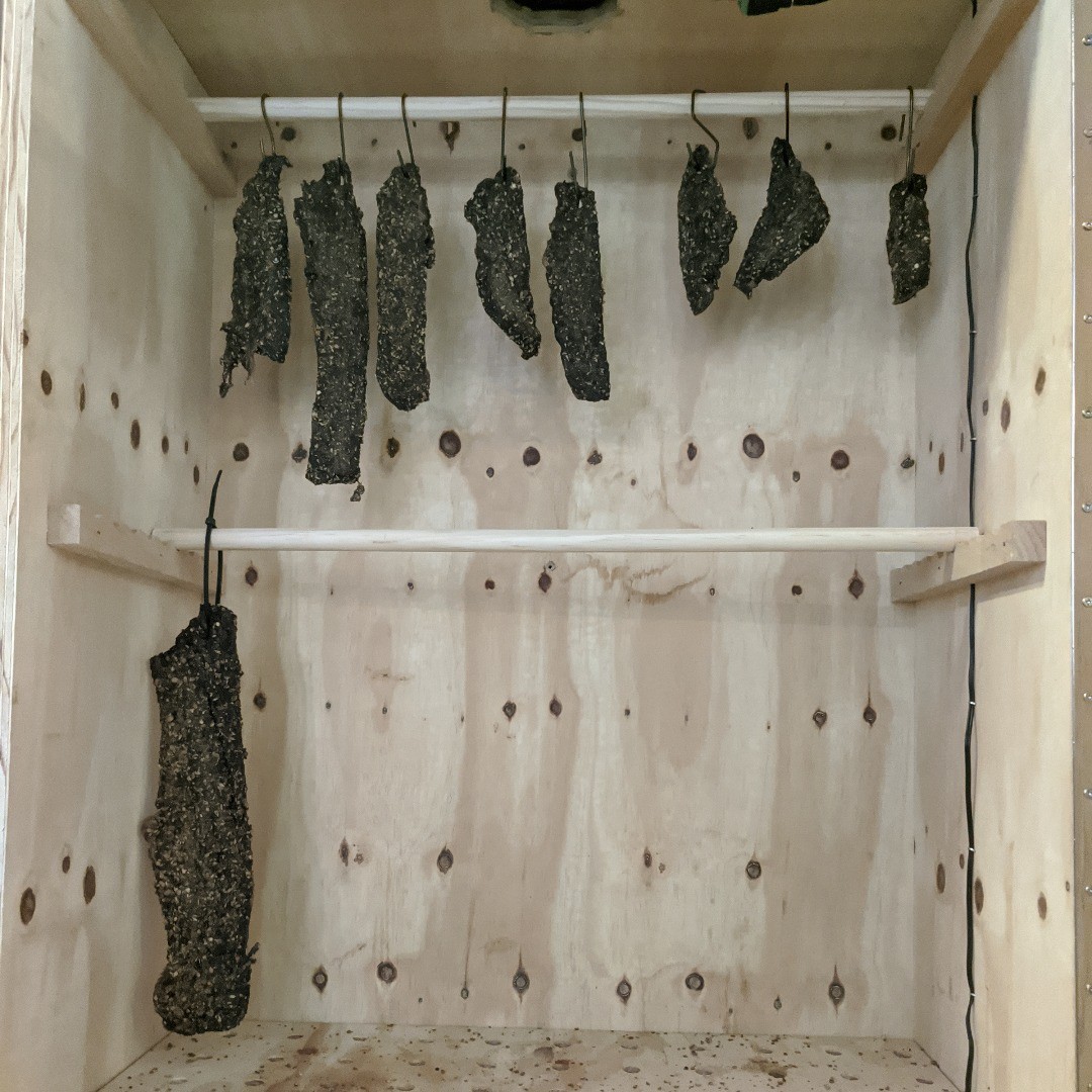 Spiced beef hanging to air-dry in Alby's drying cabinet