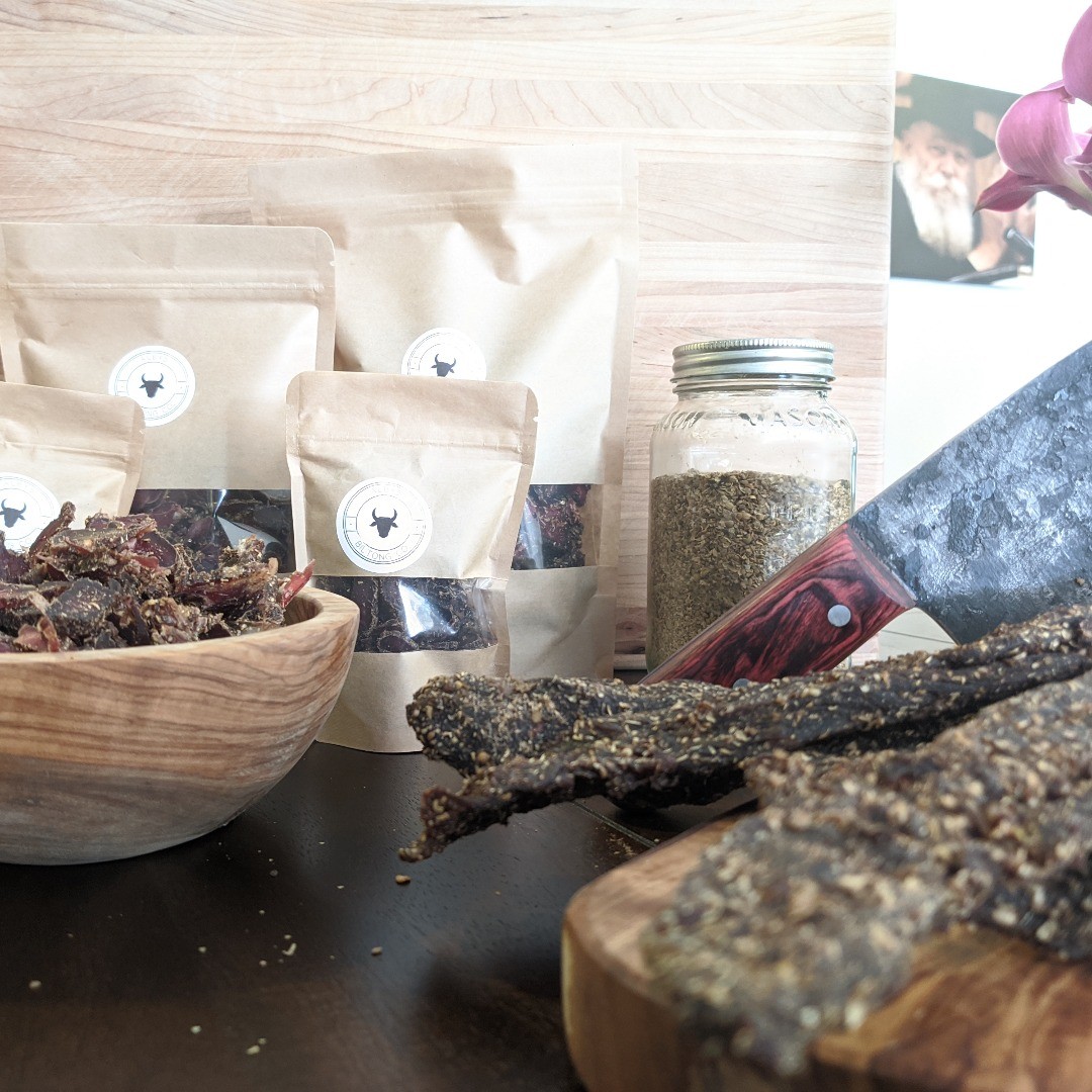 A fresh batch of Alby's biltong — hand-packed bags, sliced biltong, and the house spice blend